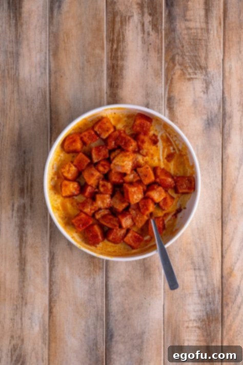 Crispy Air Fried Pork Bites 13 Air Fryer Pork bites being tossed in melted butter.