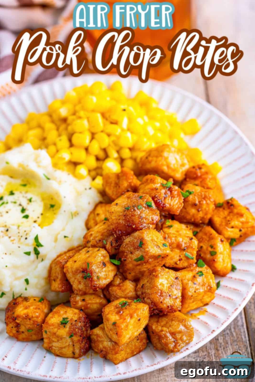 Crispy Air Fried Pork Bites 3 Looking down on a plate of Air Fryer Pork Chop Bites and mashed potatoes with corn.