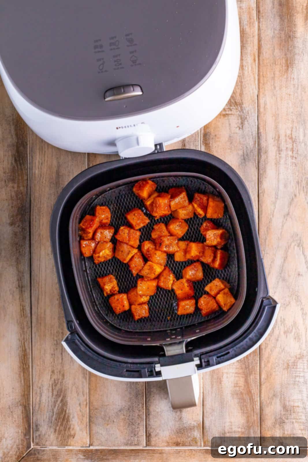 Crispy Air Fried Pork Bites 6 Air fryer basket with seasoned pork chop bites.