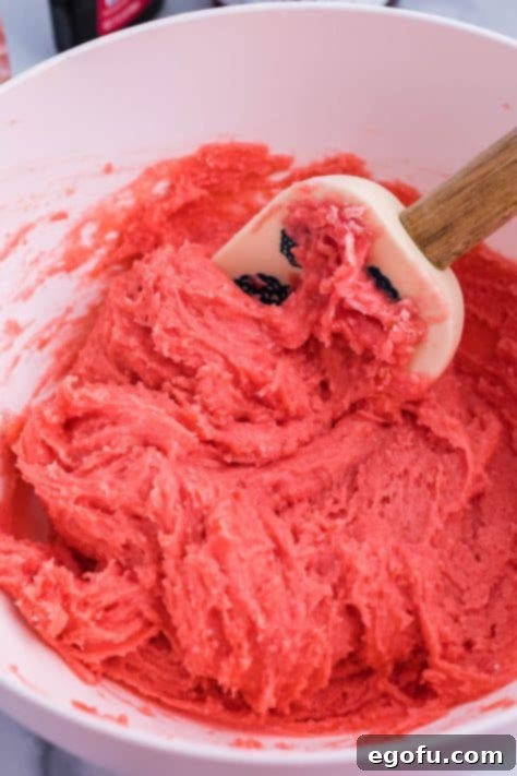 Strawberry Swirl Brownie Bliss 11 Pink brownie batter being mixed up in a mixing bowl.