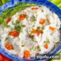 A close-up view of a bowl of smoked salmon dip, showcasing its creamy texture and visible flakes of salmon on top.