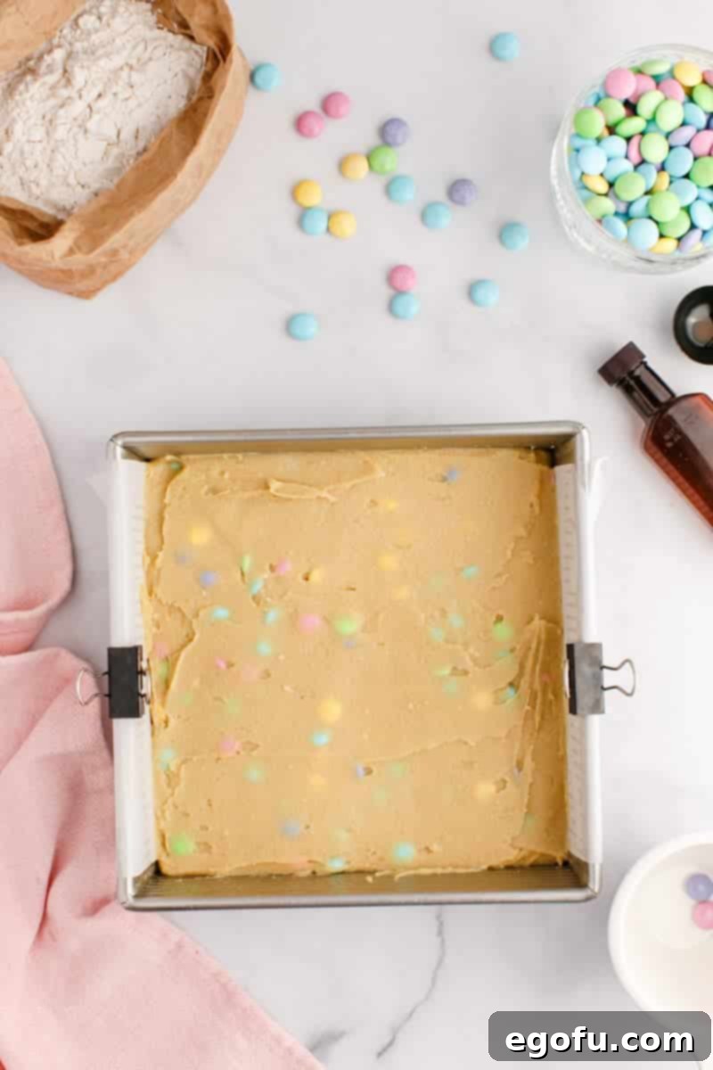 Easter Blondie batter mix spread out on a pan.