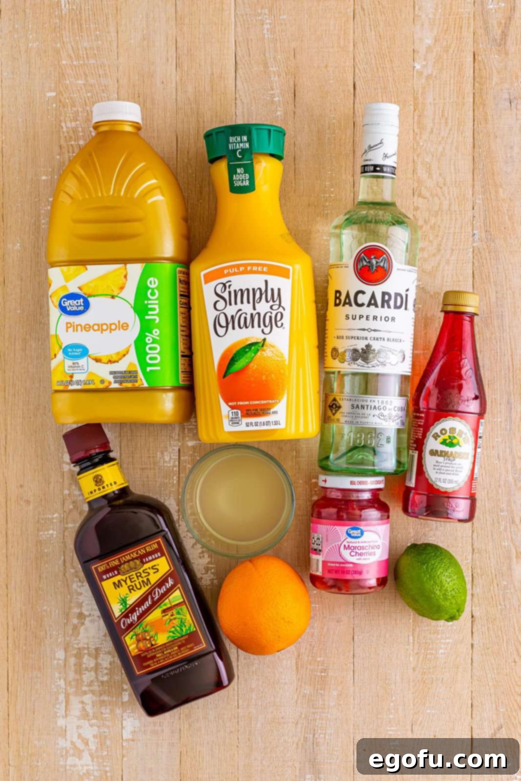 Island Dream Sip 3 Pineapple juice, orange juice, grenadine, dark rum, white rum, orange, lime, and maraschino cherries – all ingredients for Rum Punch laid out.