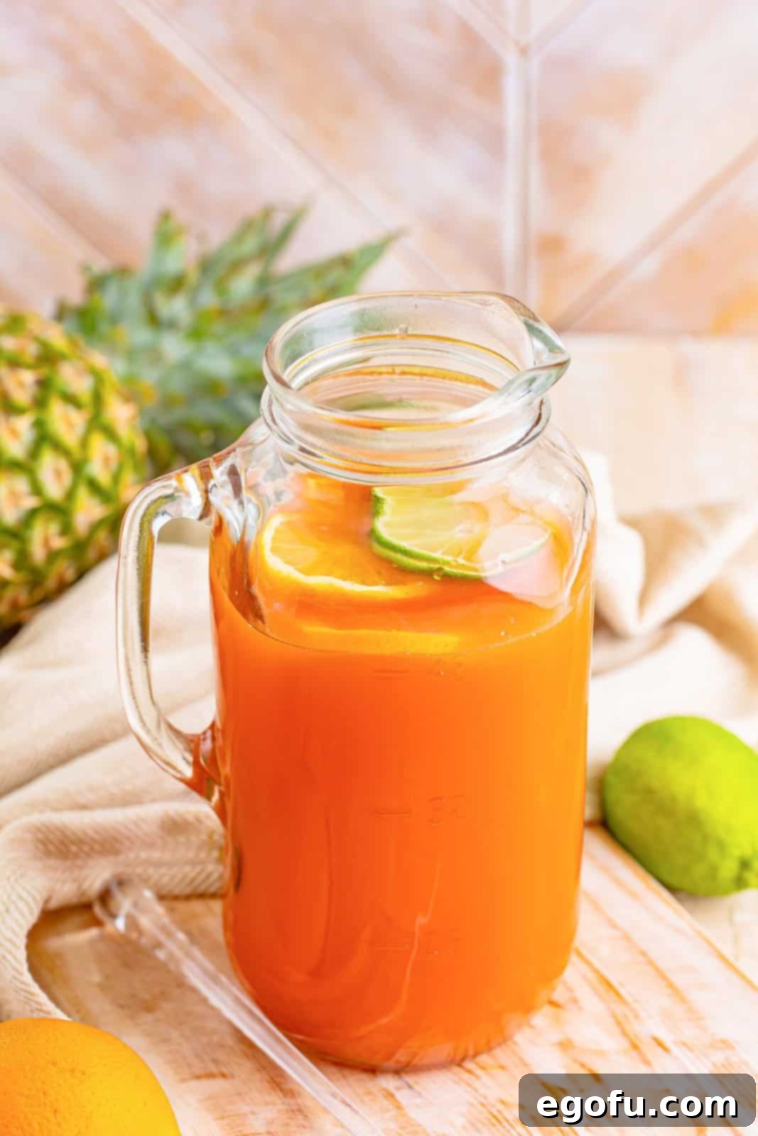 Island Dream Sip 8 A jar pitcher of Rum Punch, garnished with orange and lime slices.