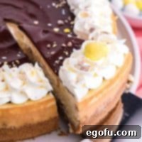 A slice of Cadbury Mini Egg Cheesecake being cut.