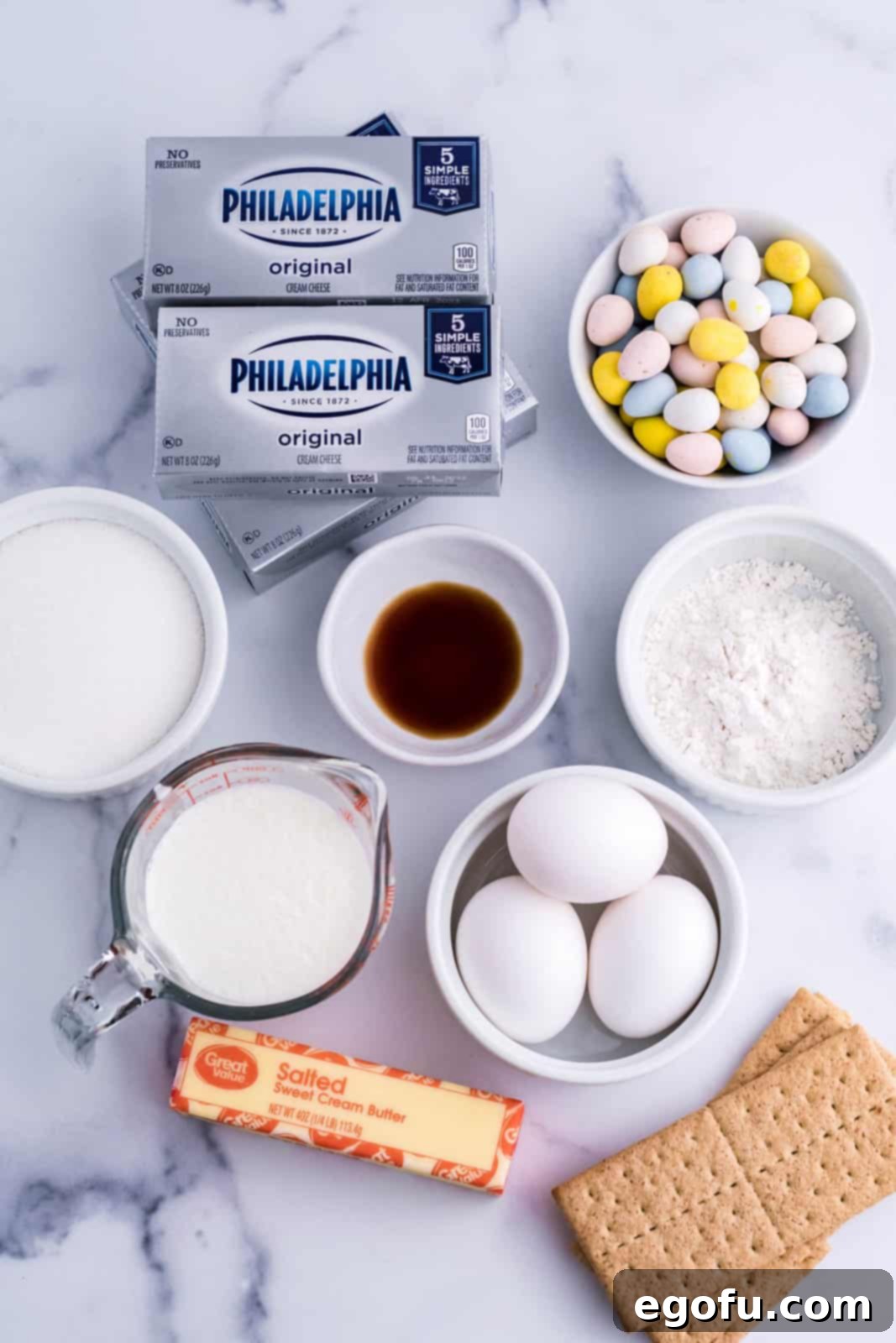 Eggs, butter, cream cheese blocks, cadbury eggs, graham crackers, heavy whipping cream, sugar, all purpose flour, chocolate chips, and vanilla extract. 