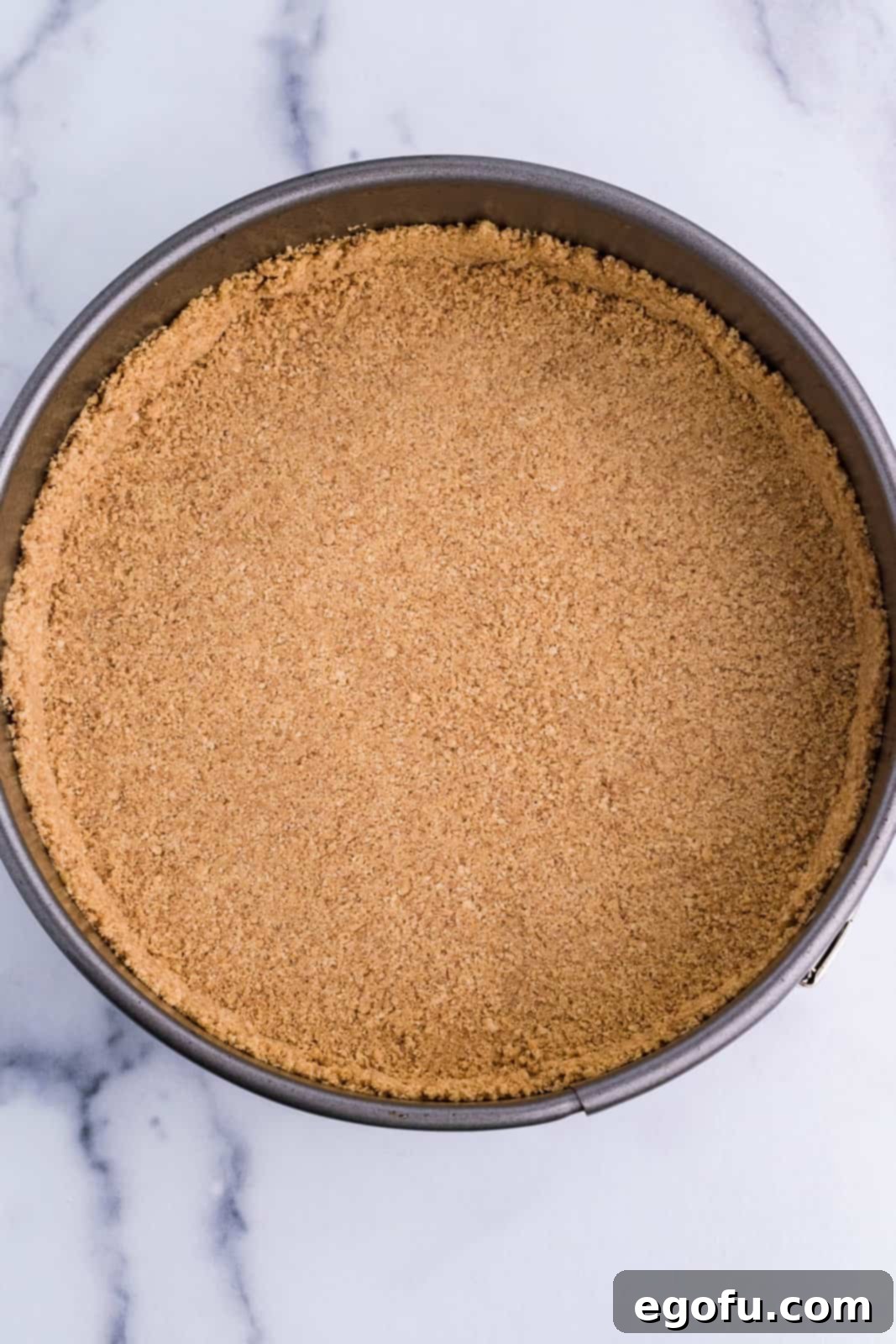 A graham cracker crust in a pan.