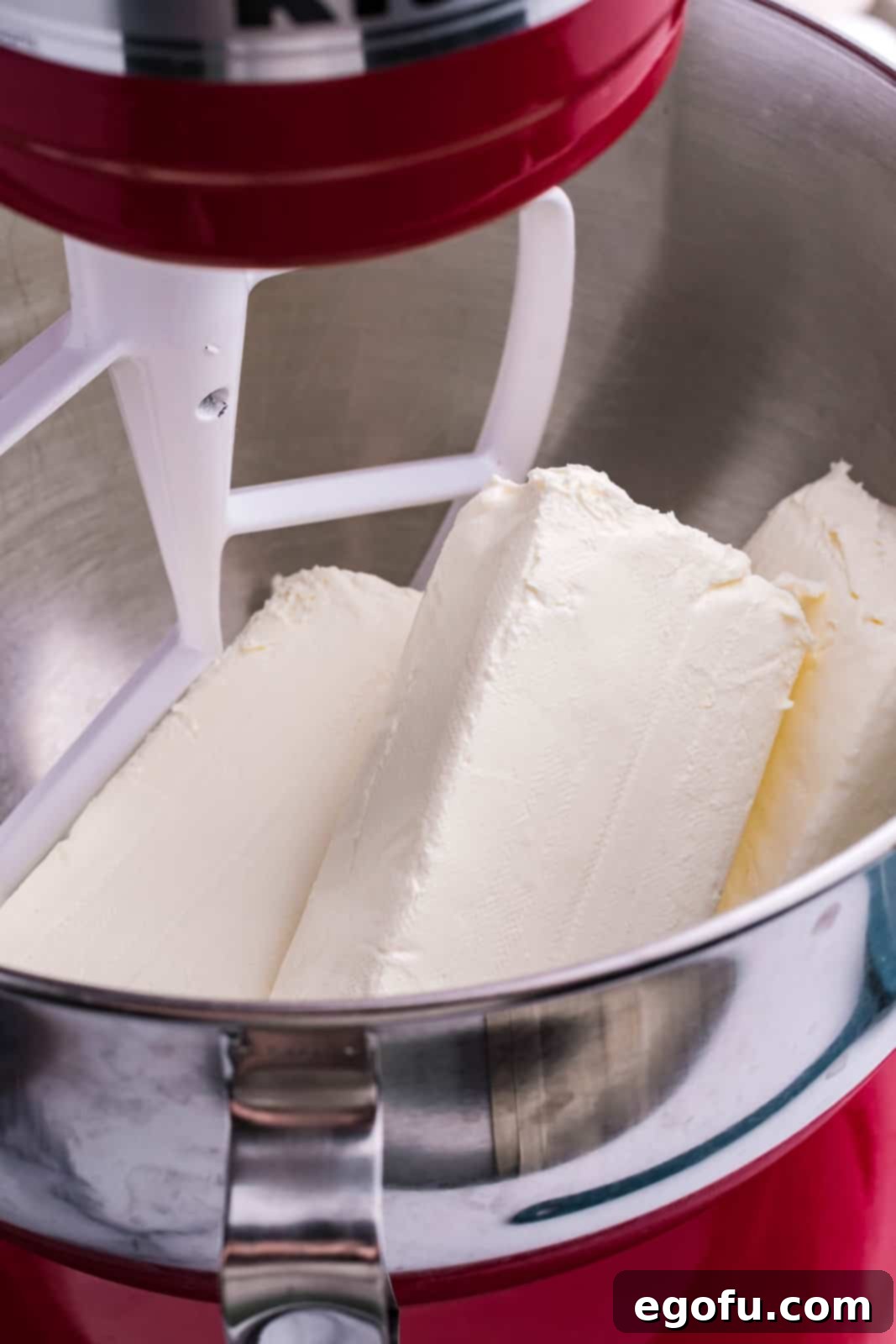 A mixing bowl with cream cheese.