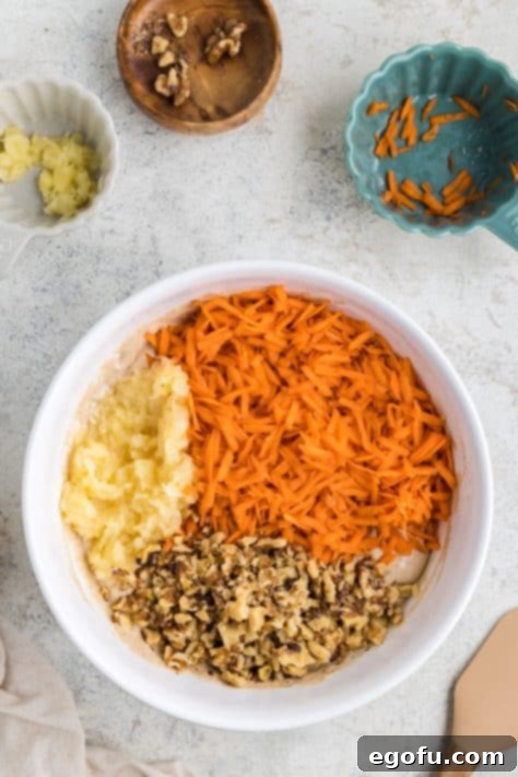 Carrots, pineapple, and walnuts on top of cake batter.