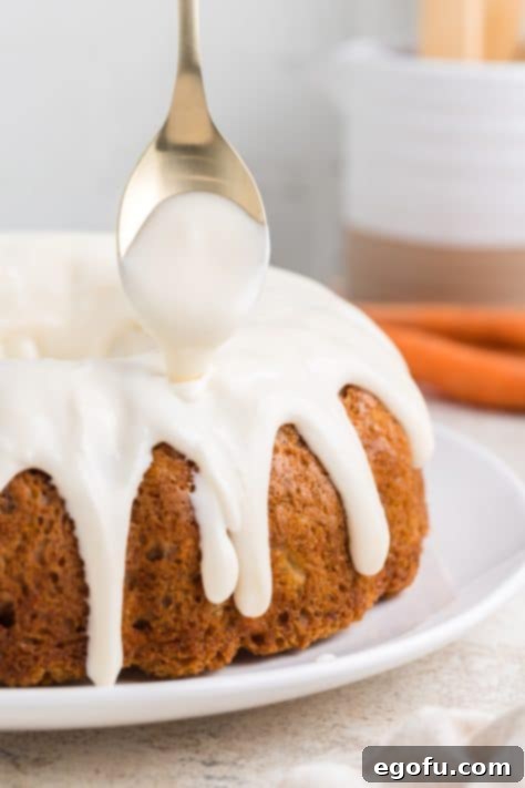 Glaze being poured on a bundt cake.