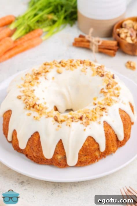 A homemade Carrot Bundt Cake with glaze on a serving plate.