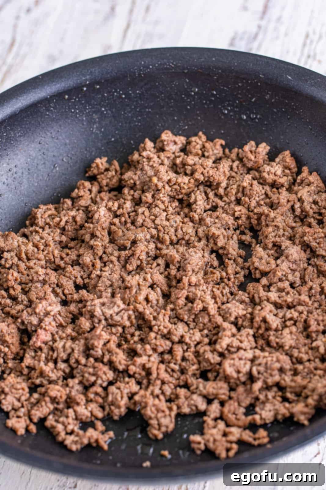 A skillet filled with perfectly cooked and crumbled ground beef, ready for seasoning.