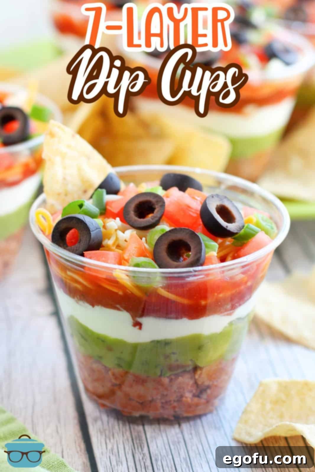 Close up looking at a layered cup with mexican dip.