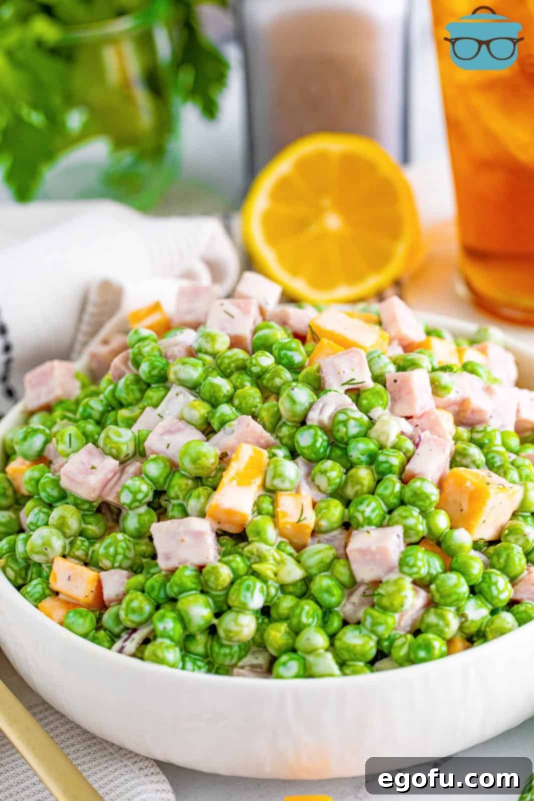 Creamy Garden Pea Salad 2 Looking at a serving bowl of pea salad.