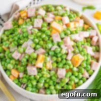 Creamy Garden Pea Salad 9 A bowl of ham and pea salad.