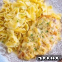Looking down on a plate of Creamy Garlic Chicken with pasta.