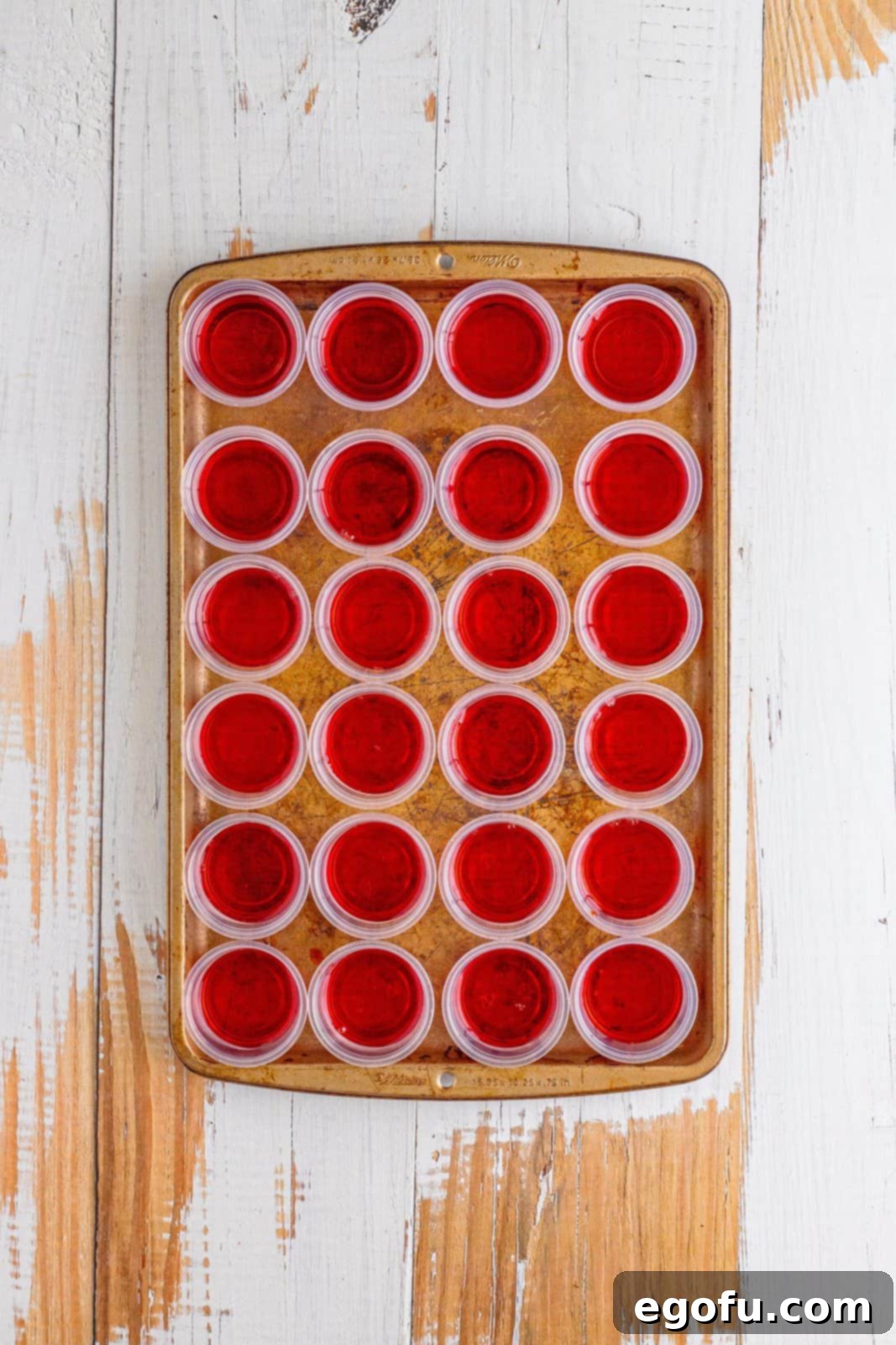 Agave Aurora Shots 6 Cherry Jello shot layer in mini jello shot cups on a baking tray.