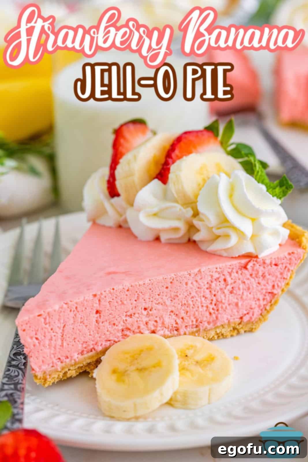 A slice of Strawberry Banana Jello Pie with garnishes on top.