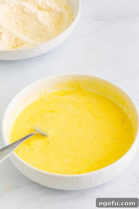 Down Home Fried Squash 13 A small bowl with buttermilk, egg, and flour.