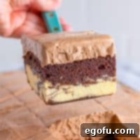 Amore Italian Dream Cake 9 A serving utensil holding a slice of Italian Love Cake.