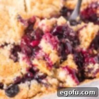 Close up looking at a bite of Blueberry Dump Cake.