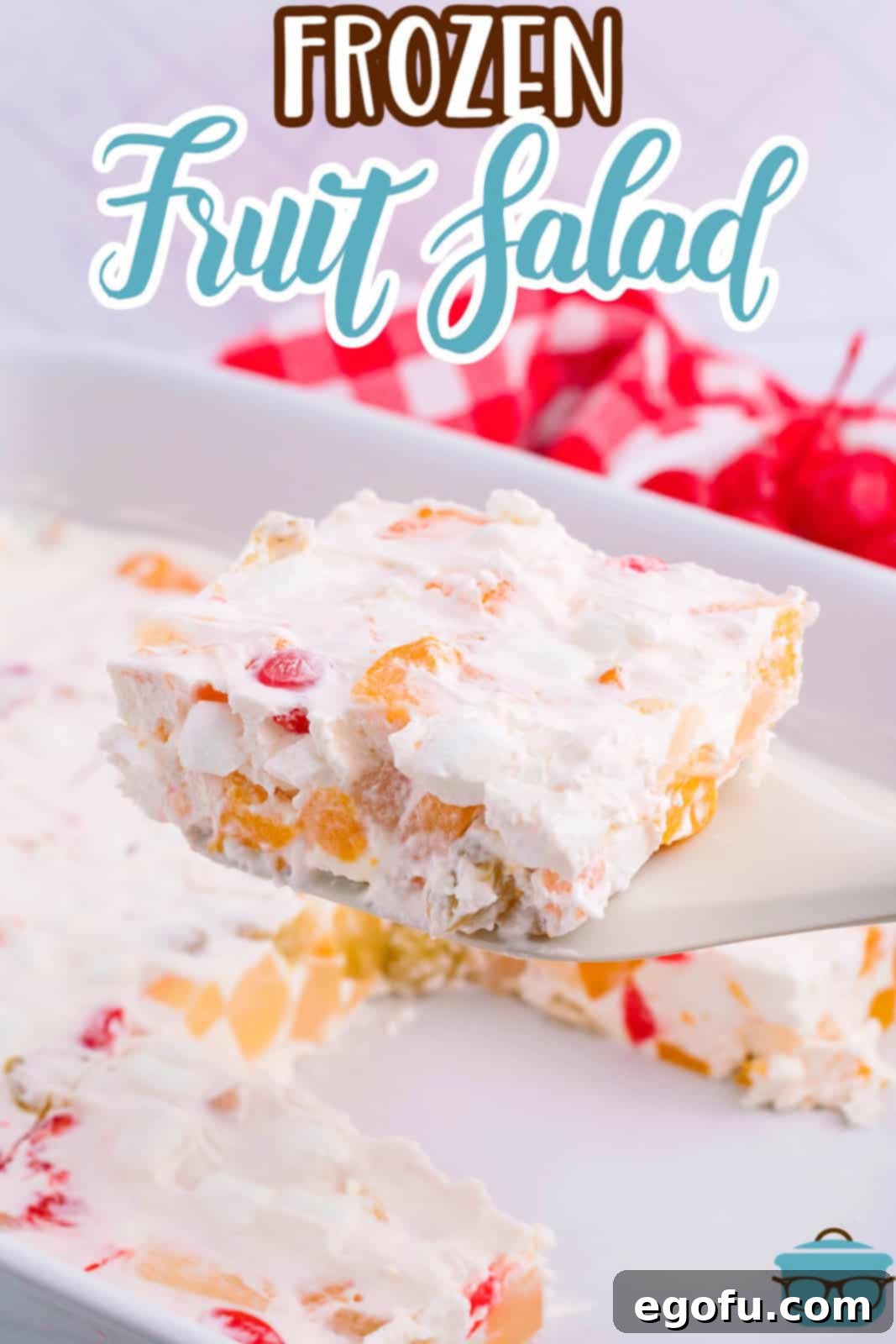 A vibrant serving of frozen fruit salad on a decorative plate, showcasing the mix of colorful fruits and creamy white base.