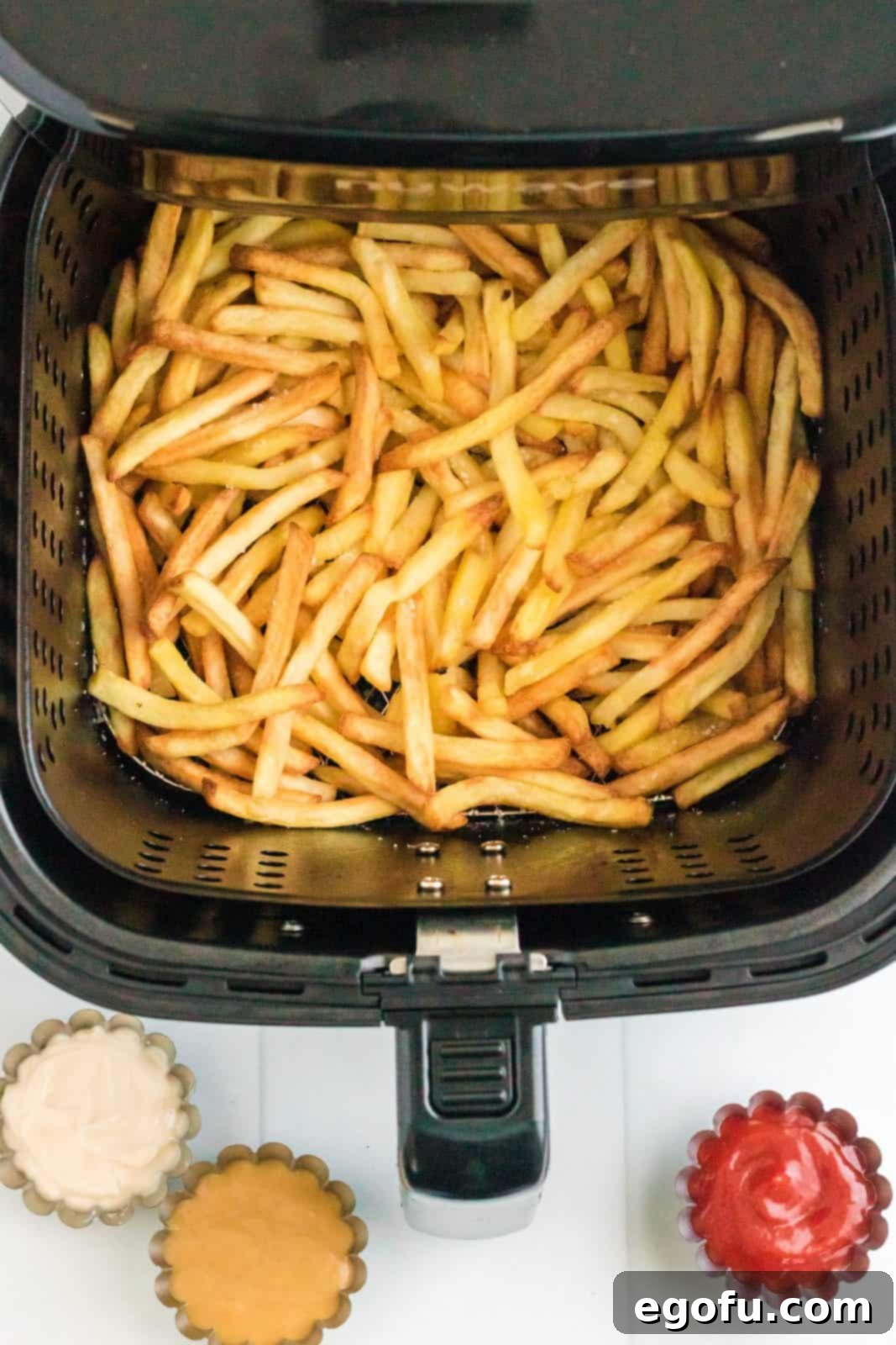 Transform Your Oven Classics for Air Fryer Perfection 6 Crispy finished french fries in air fryer basket.