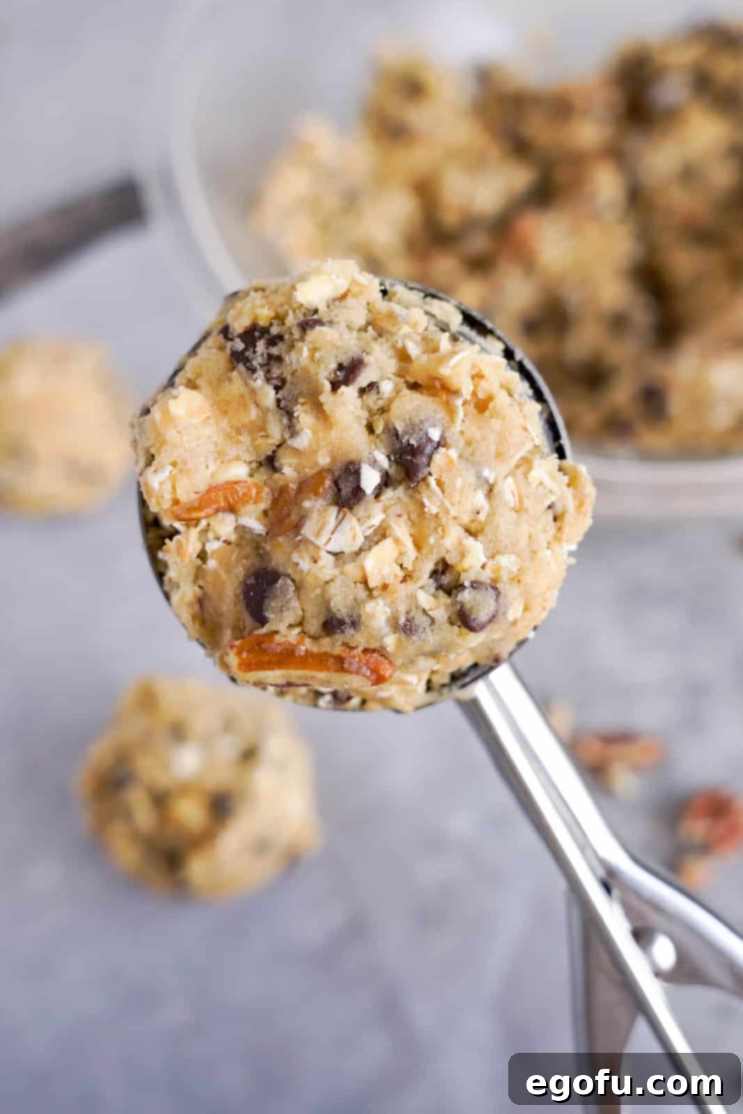 Oatmeal Chocolate Chip Delights 9 Using a cookie scoop to portion oatmeal chocolate chip cookie dough onto a baking sheet, ensuring even size and spacing.