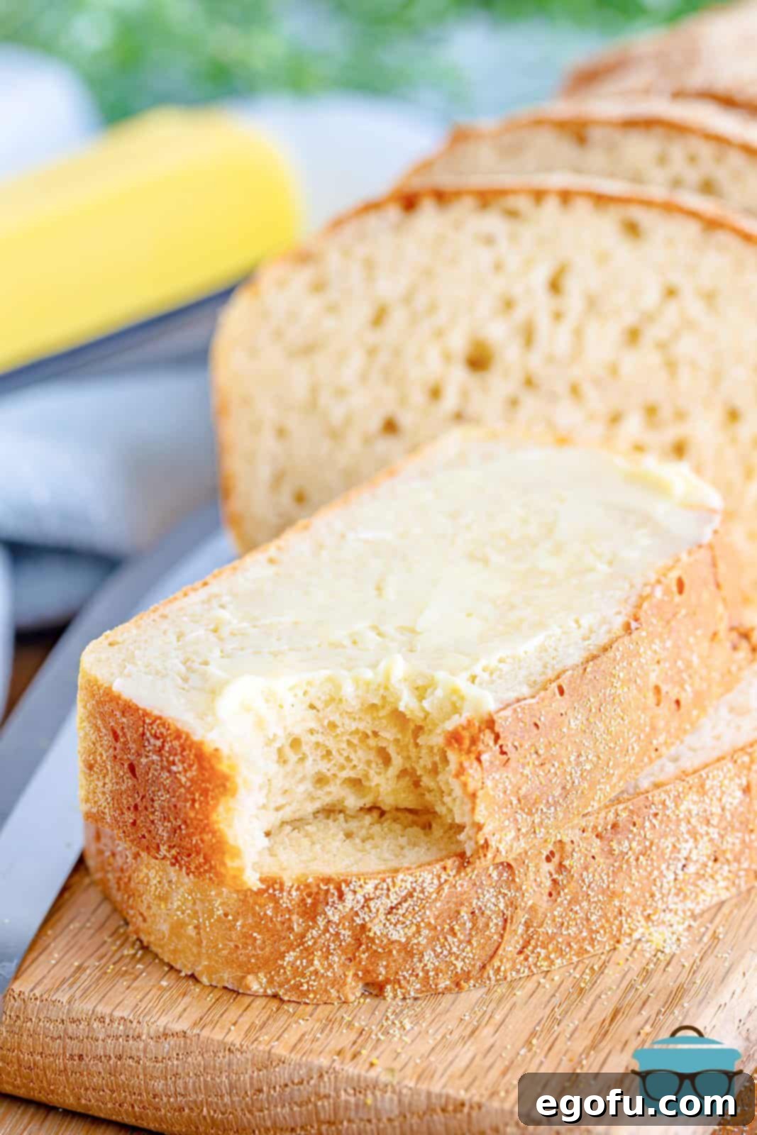 Slices of English muffin bread stacked with one bite removed from one of the slices. 