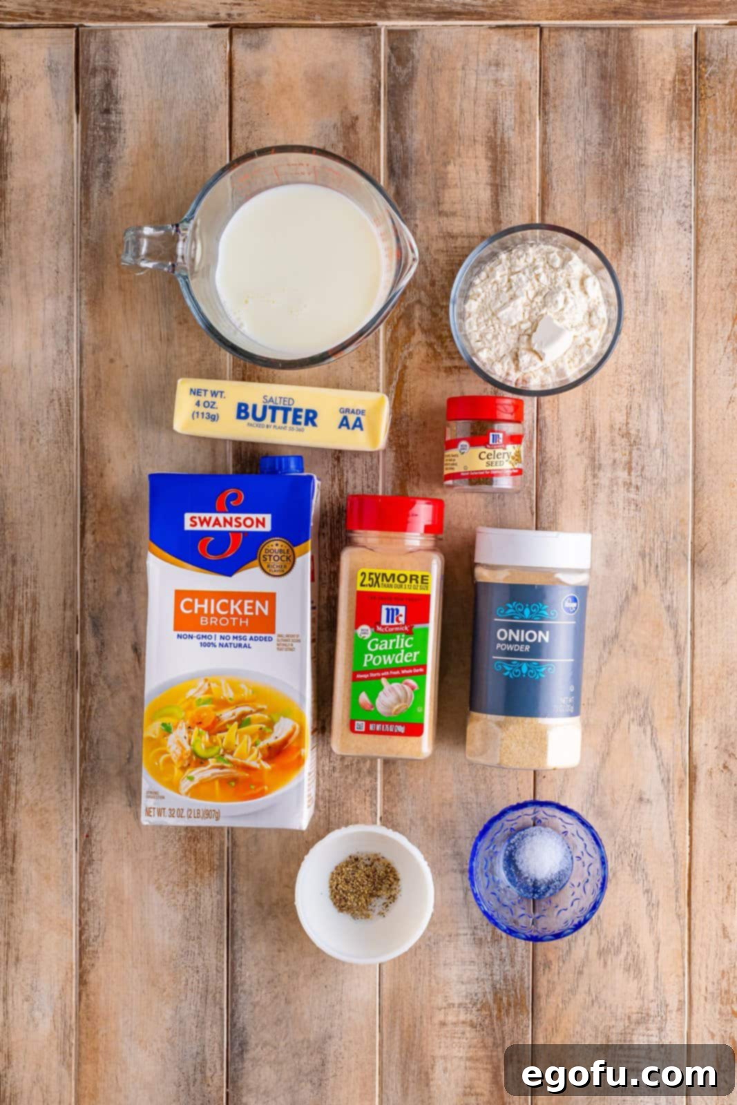 A collage displaying all the key ingredients for homemade cream of chicken soup: salted butter, flour, various spices, chicken broth, and milk, neatly arranged on a rustic surface.