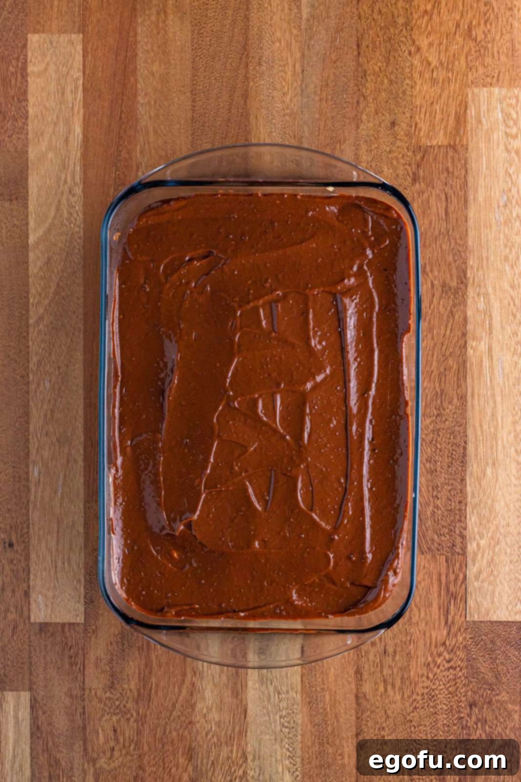 Golden Butterfinger Dream 11 A layer of rich chocolate pudding smoothly spread over the peanut butter cream cheese layer in the baking dish.