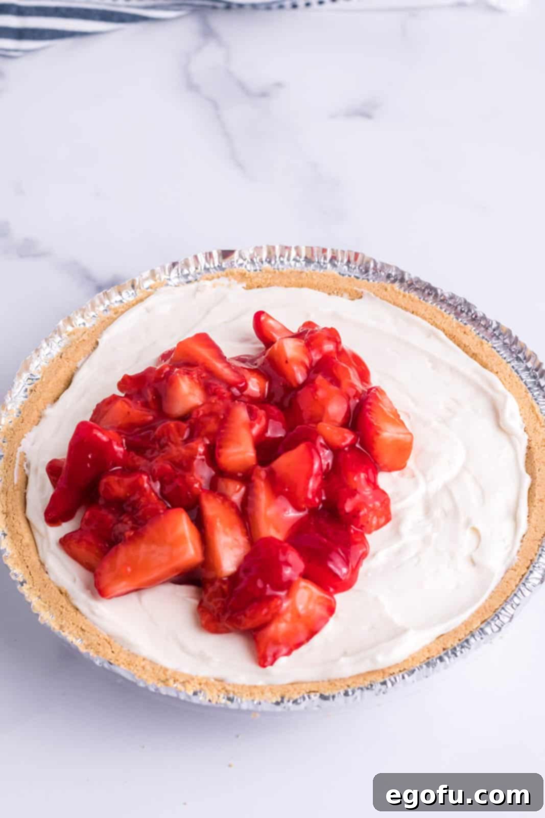 The strawberry filling layer spread beautifully on top of the cream cheese layer in the pie crust.