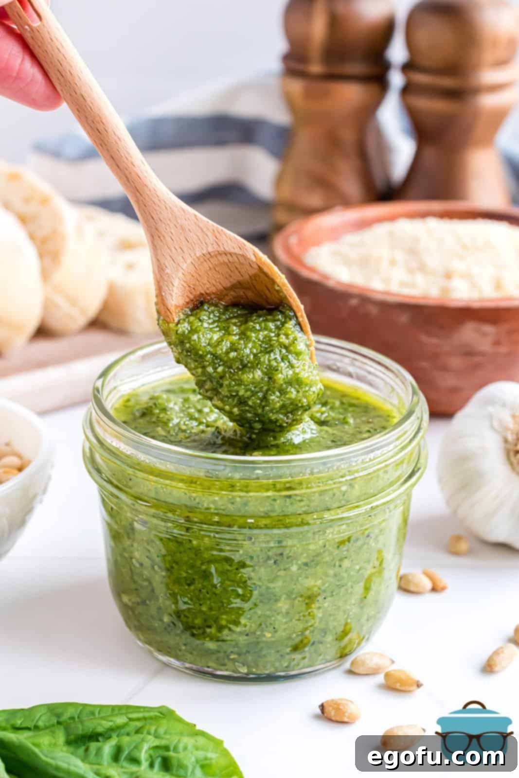 A wooden spoon with some homemade basil pesto.