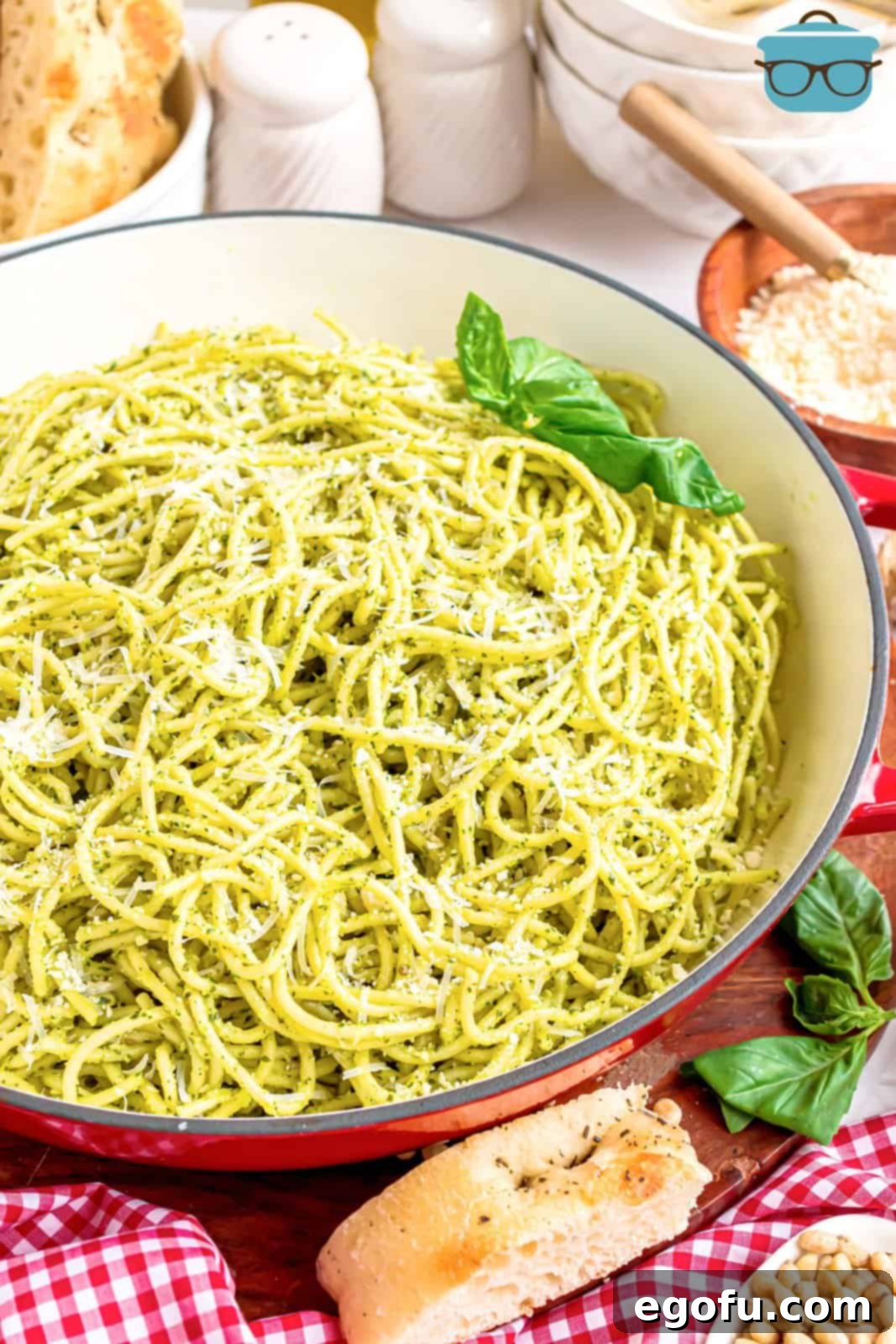 A vibrant bowl of Pesto Pasta garnished with fresh basil leaves, ready to be enjoyed.