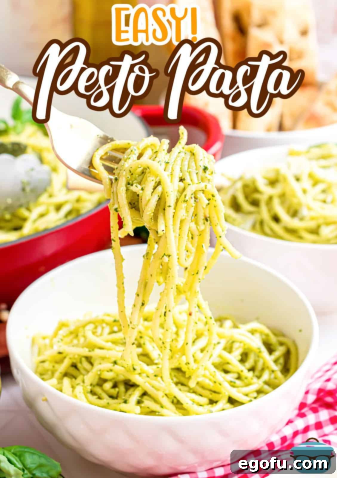 A fork twirling a bite of perfectly sauced Pesto Pasta, ready to be eaten.
