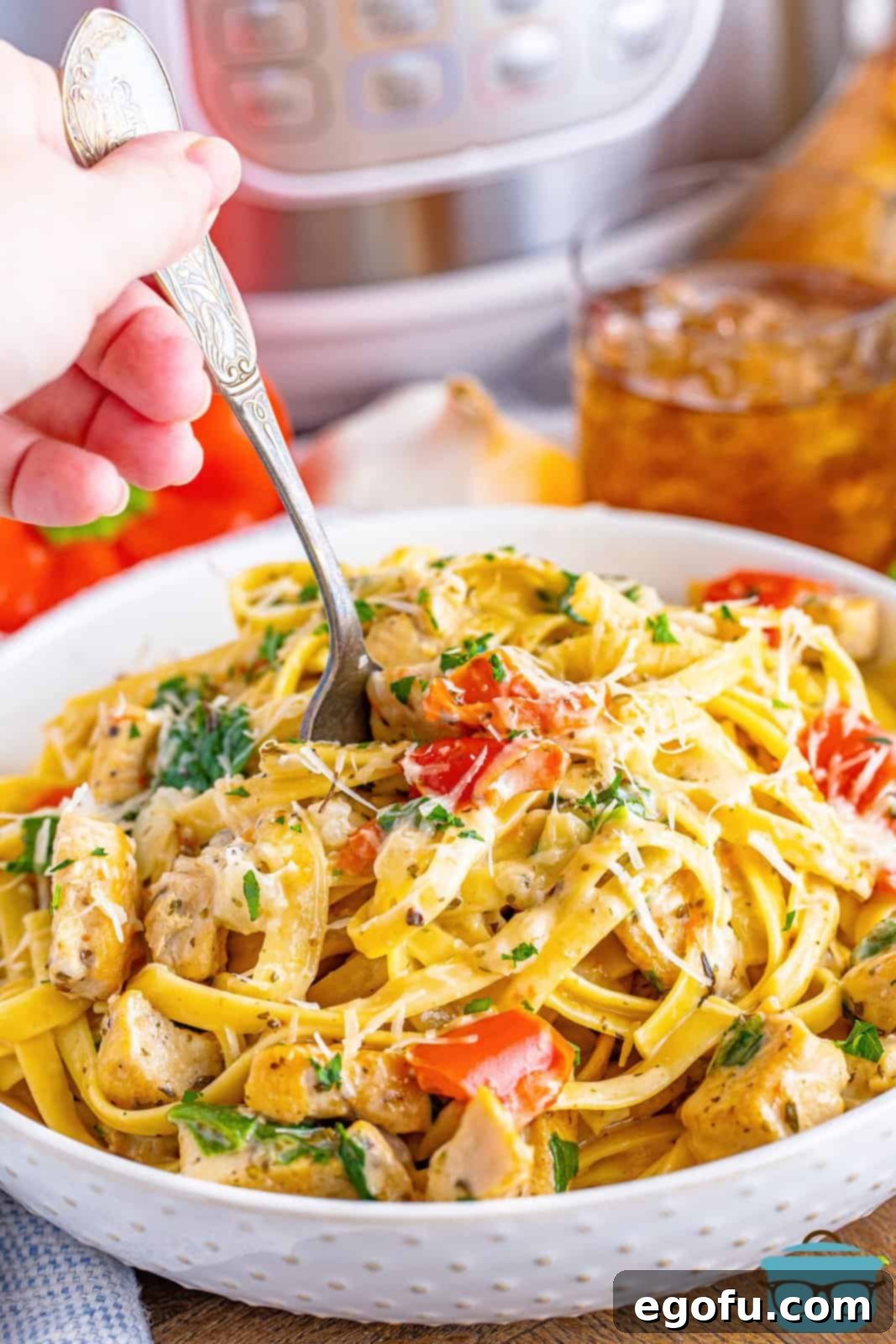 A bowl of Creamy Garlic Pasta with a utensil in it.