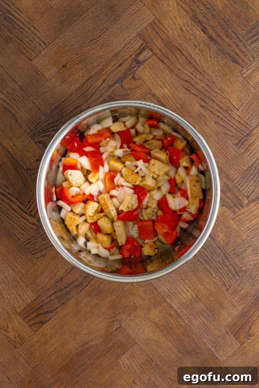 Onions, bell pepper, and chicken in the Instant Pot.