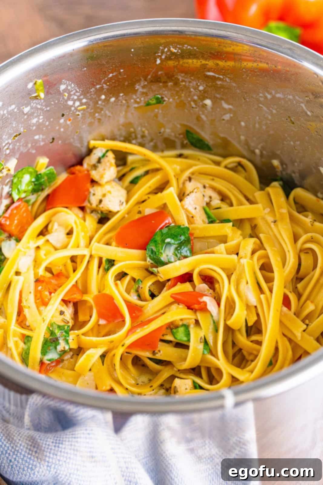 The Instant Pot insert making creamy garlic chicken pasta.