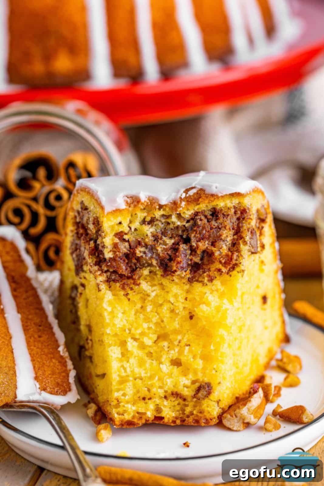 A slice of sock it to me cake with a bite missing.