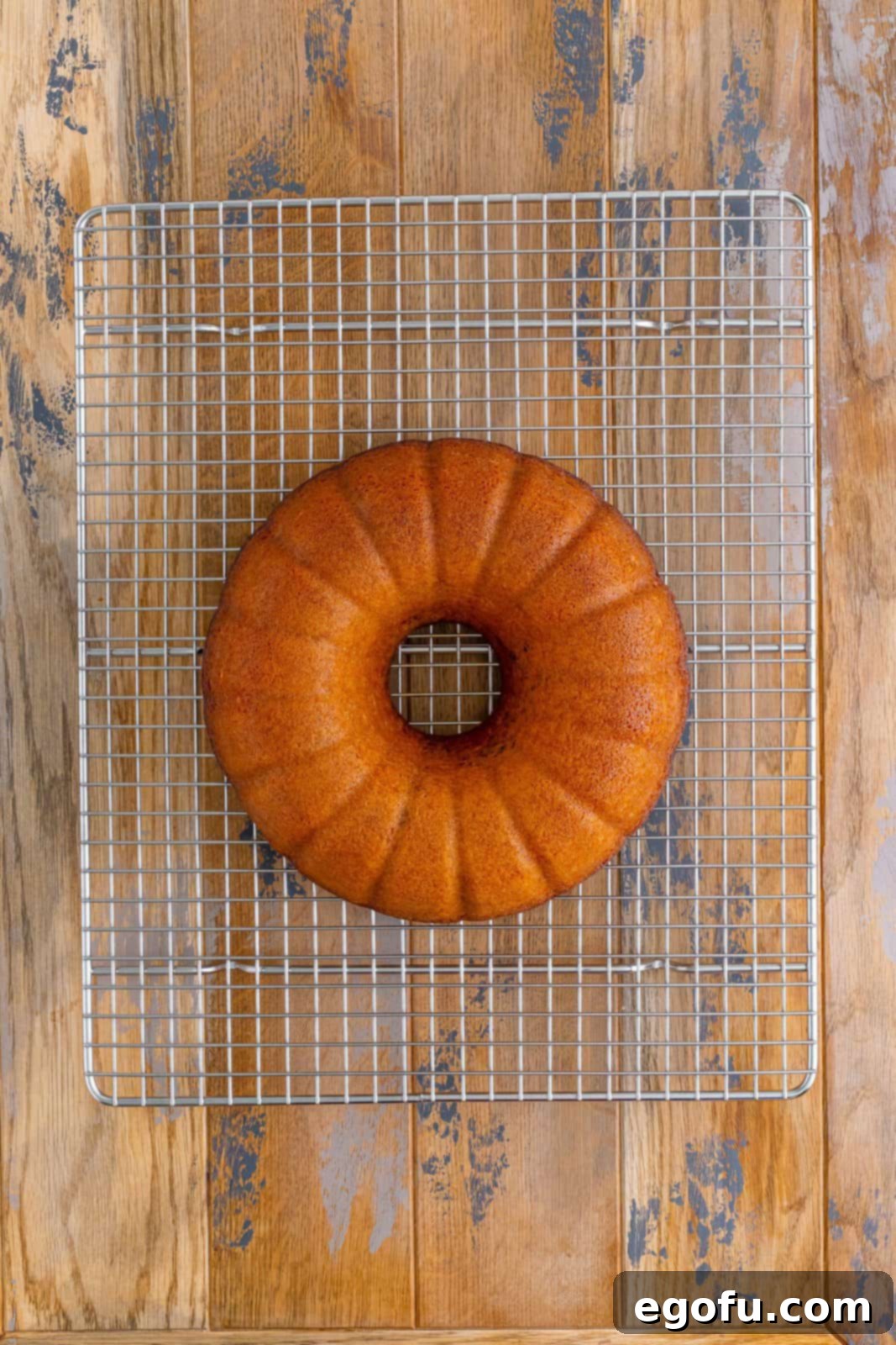 A Sock It To Me Bundt Cake on a wire rack cooling.