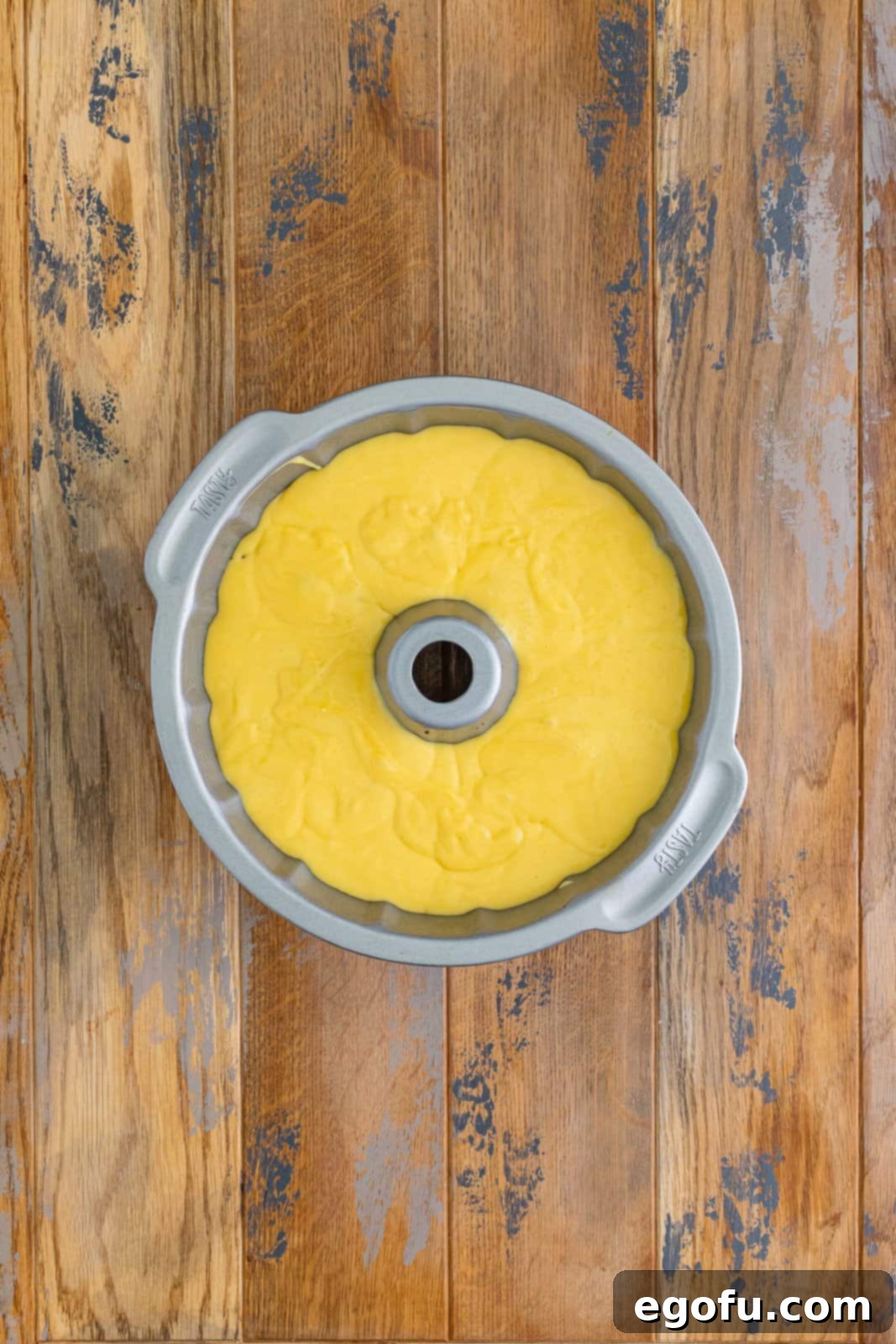A bundt pan with the sock it to me cake batter and filling in it. 