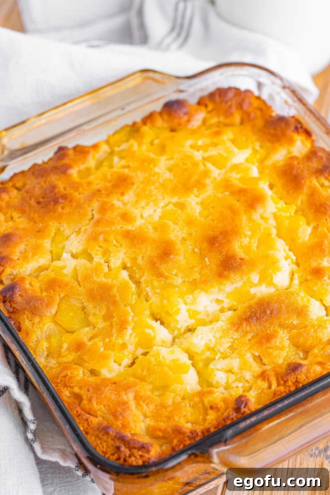 Sun-Kissed Peach Butter Swim Biscuits 11 Freshly baked Peach Butter Swim Biscuits in the baking dish, golden brown and fluffy.