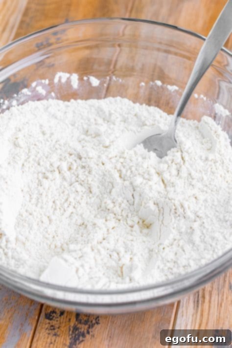 Sun-Kissed Peach Butter Swim Biscuits 16 A mixing bowl with flour, sugar and baking powder.