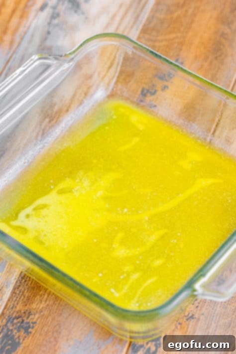 Sun-Kissed Peach Butter Swim Biscuits 19 Melted butter in a baking dish.