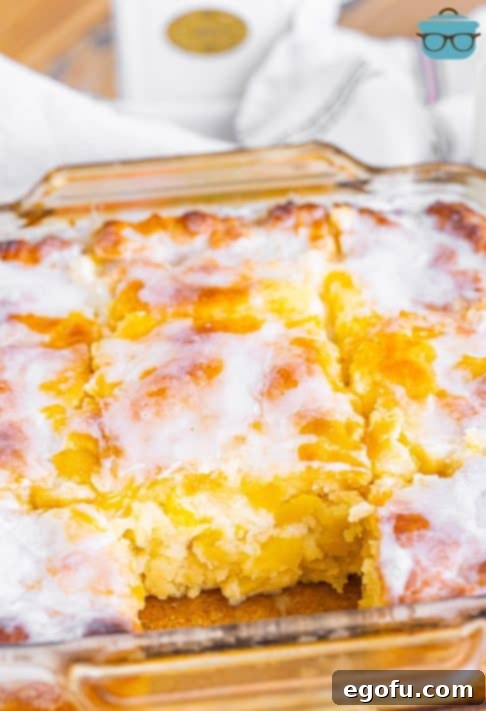 Sun-Kissed Peach Butter Swim Biscuits 24 A baking dish full of Peach Butter Swim Biscuits with one missing.