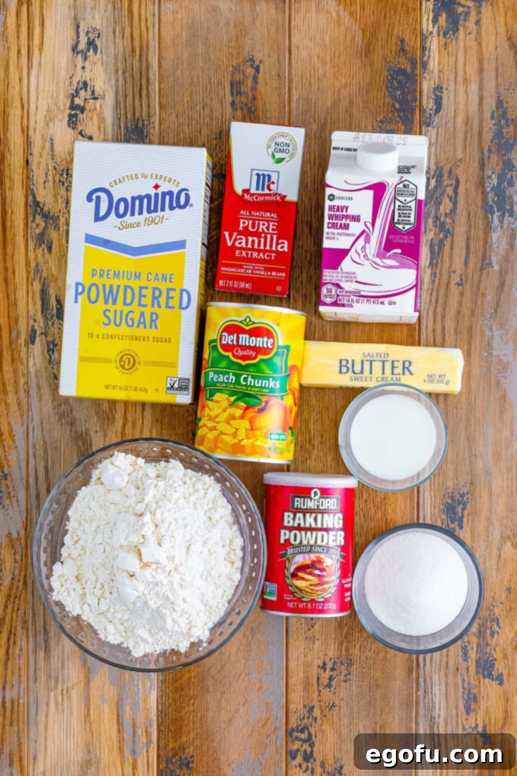 Sun-Kissed Peach Butter Swim Biscuits 4 A clear glass bowl filled with all-purpose flour, granulated sugar, and aluminum-free baking powder, ready for mixing.