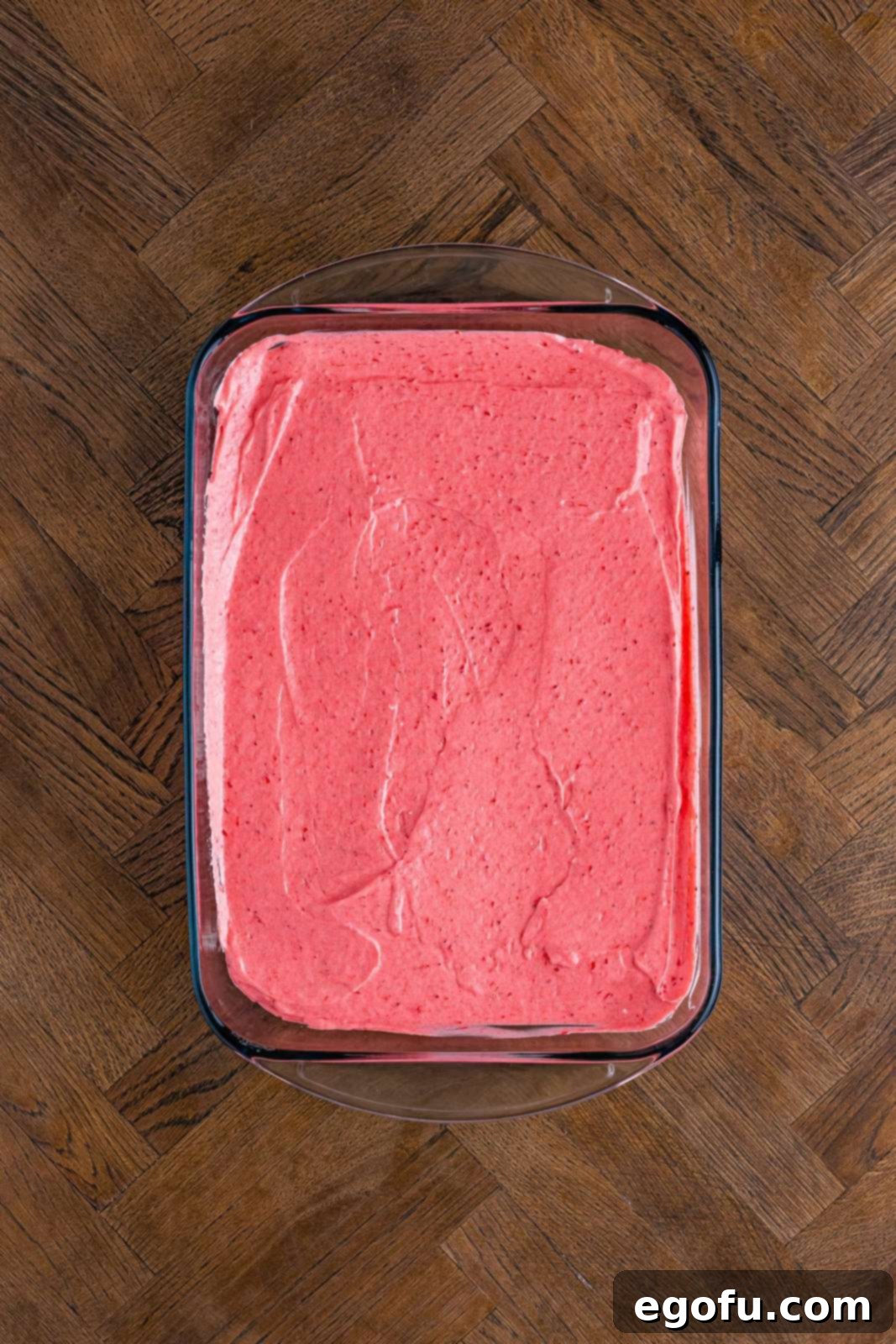 Layered Strawberry Bliss 11 The strawberry pie filling layer smoothed out over the golden Oreo crumb crust in a baking dish.