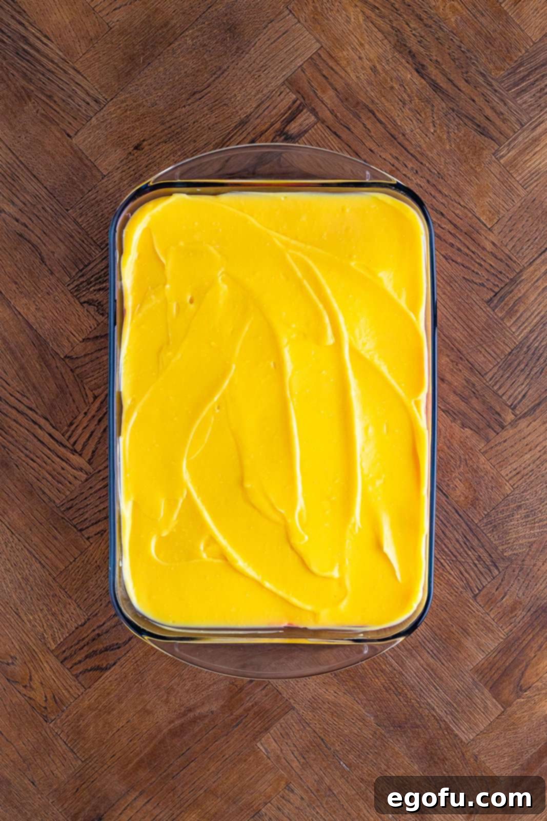 Layered Strawberry Bliss 12 A smooth vanilla pudding layer spread over the strawberry layer in a baking dish.