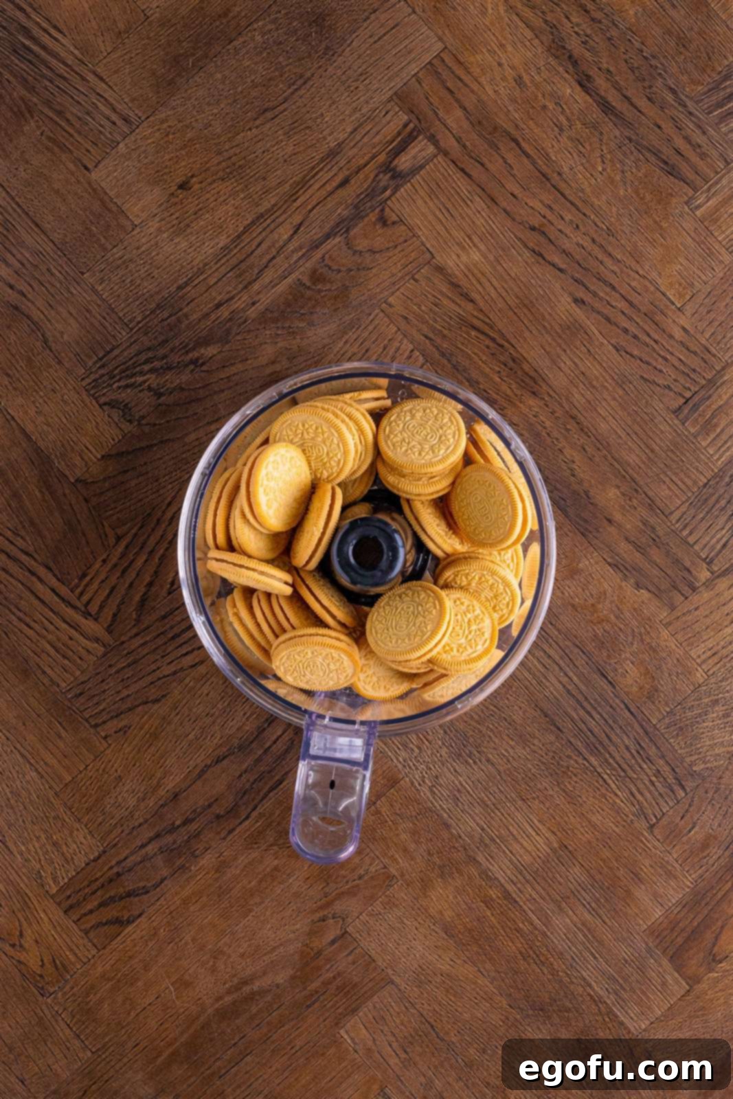 Layered Strawberry Bliss 5 Golden Oreos being crushed in a food processor cup.