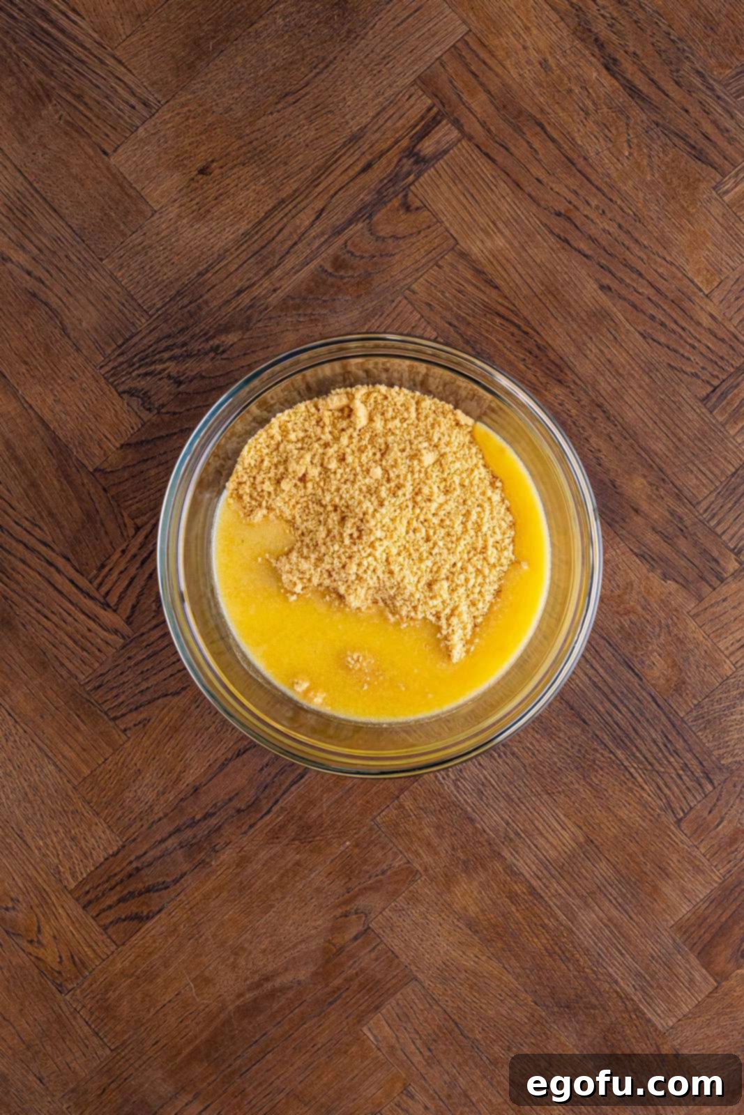 Layered Strawberry Bliss 6 Melted butter and crushed golden Oreo crumbs mixed together in a bowl.